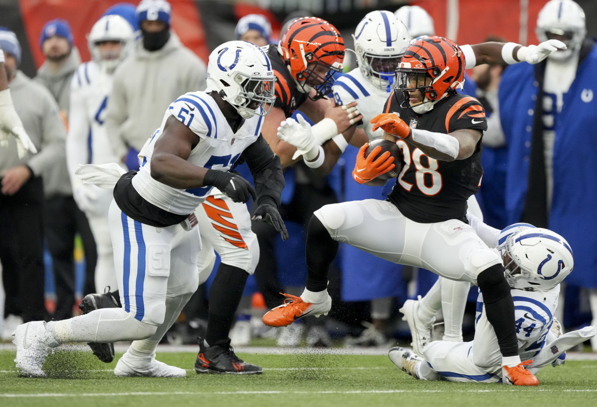 Dec 10, 2023; Cincinnati, Ohio, USA; Cincinnati Bengals running back Joe Mixon (28) looks to advance the ball past Indianapolis Colts defensive end Kwity Paye (51) at Paycor Stadium. Mandatory Credit: Bob Scheer-USA TODAY Sports